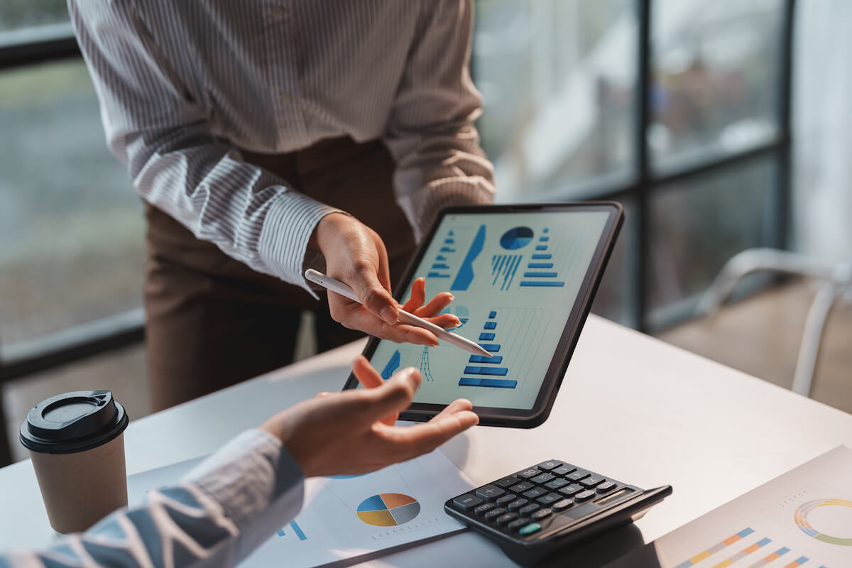 Consultant reviewing business financials on a tablet